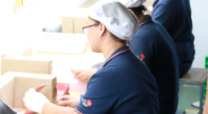 SMILE Group manufacturing floor with skilled operators assembling packaging